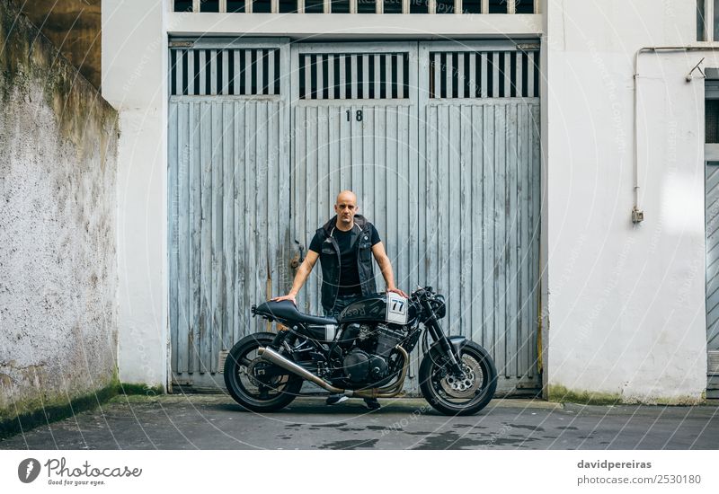 Builder posing with a motorcycle Lifestyle Style Trip Engines Human being Man Adults Street Vehicle Motorcycle Bald or shaved head Stand Authentic Retro Black
