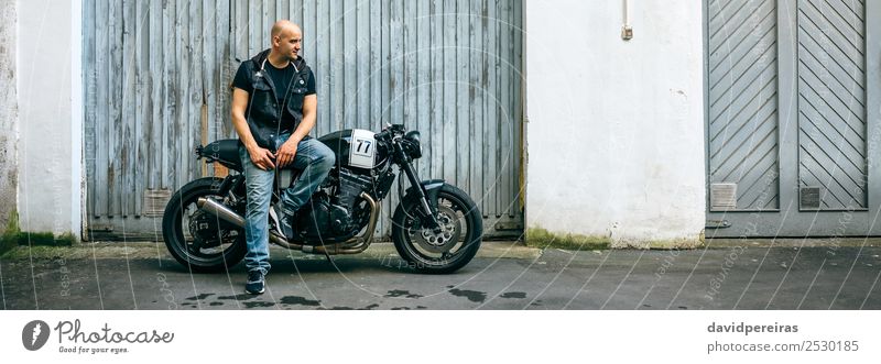 Biker posing with a motorcycle Lifestyle Style Engines Human being Man Adults Street Vehicle Motorcycle Bald or shaved head Smiling Sit Authentic Retro Black