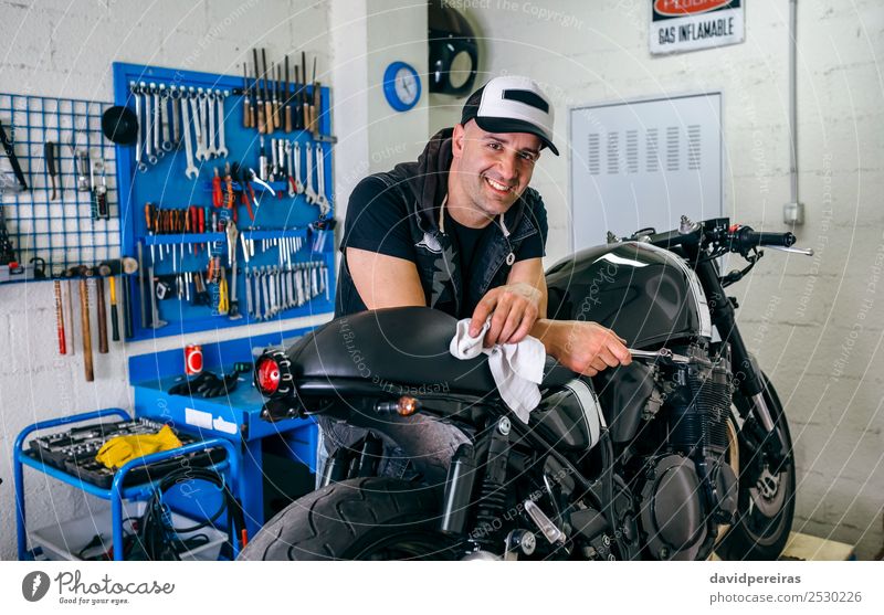 Mechanic posing with a motorcycle Lifestyle Style Happy Work and employment Engines Human being Man Adults Vehicle Motorcycle Cloth Smiling Authentic Retro