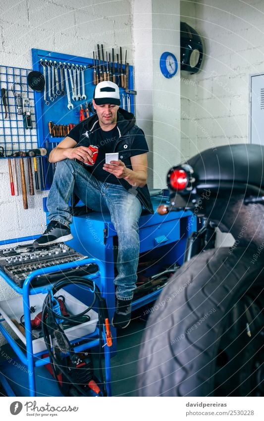 Motorcycles mechanic resting having a beer Drinking Beer Lifestyle Style PDA Engines Human being Man Adults Vehicle Sit Authentic Retro break mobile Workbench