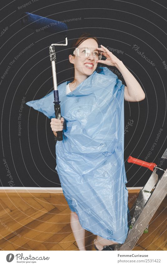 Woman in protective clothes posing with a blue paint roller #DIY Leisure and hobbies Feminine Adults 1 Human being 18 - 30 years Youth (Young adults) Resolve