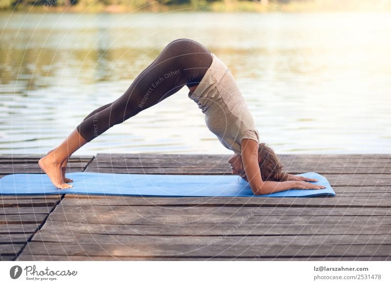 Attractive woman working out on a wooden deck Lifestyle Happy Body Wellness Meditation Summer Ocean Yoga Woman Adults 1 Human being 18 - 30 years