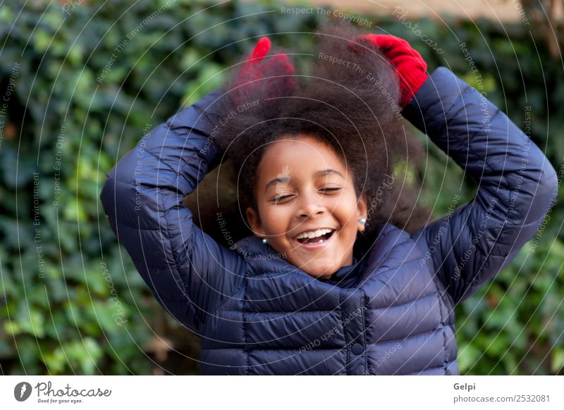 Cute African American girl smiling in the street with afro hair - a Royalty  Free Stock Photo from Photocase