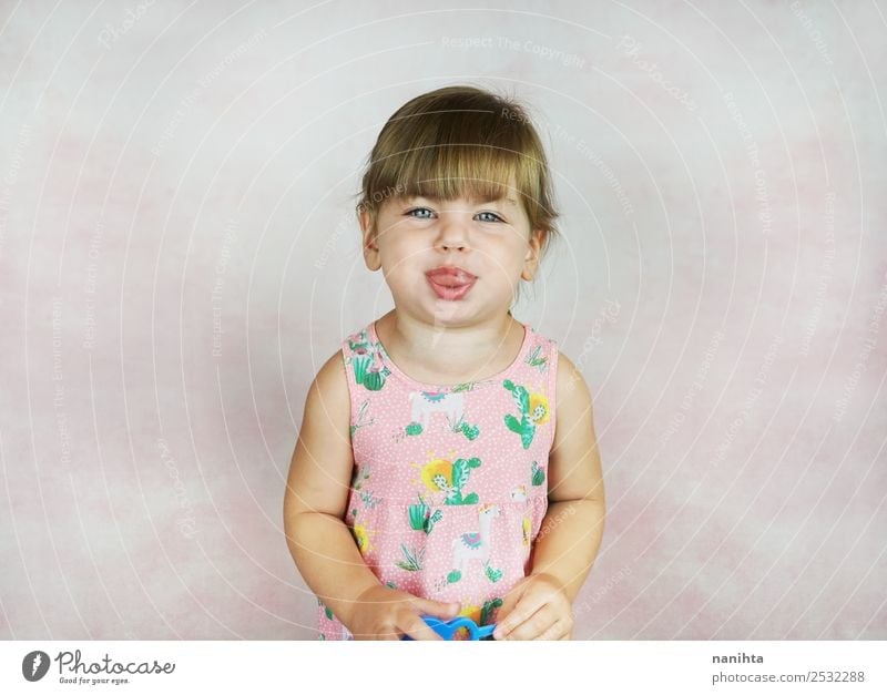 Little girl sticking out her tongue Lifestyle Style Design Joy Face Parenting Education Human being Feminine Child Toddler Girl Infancy 1 1 - 3 years Dress