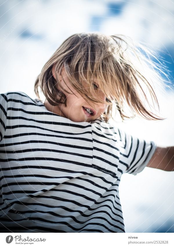 Blond boy plays with blowing hair Joy Happy Parenting Child Human being Masculine Boy (child) 1 8 - 13 years Infancy Environment Clouds Sun Beautiful weather