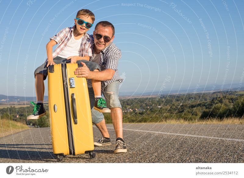 Father and son standing on the road at the day time. Concept of tourism. Lifestyle Joy Happy Playing Vacation & Travel Tourism Trip Adventure Freedom Camping