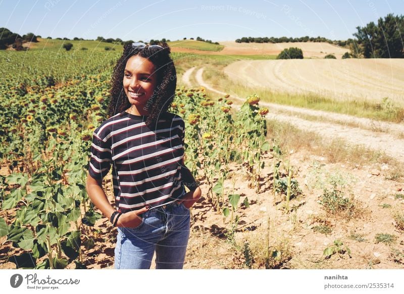Young woman enjoying the day in a field of sunflowers Lifestyle Style Wellness Vacation & Travel Freedom Summer Summer vacation Human being Feminine