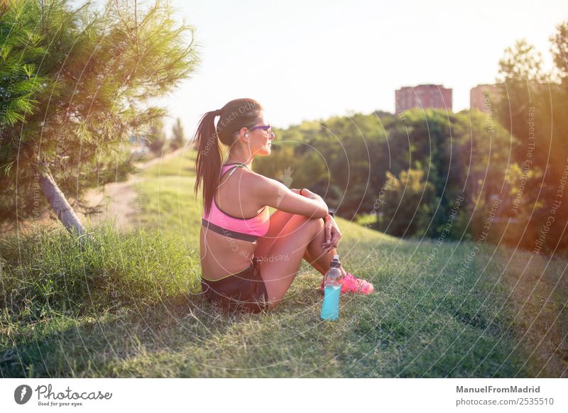 athletic woman resting Bottle Lifestyle Beautiful Summer Sports Woman Adults Nature Park Fitness Sit Energy workout Runner training Resting isotonic drink young