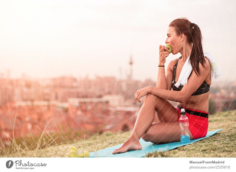 athletic woman eating an apple Fruit Apple Eating Lifestyle Beautiful Body Wellness Summer Sports Jogging Human being Woman Adults Nature Park Fitness Sit Green