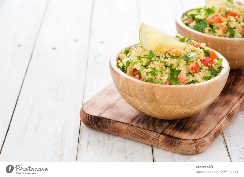 Tabbouleh salad with couscous on white wooden table Table Salad Vegetable Tomato Cucumber Parsley Mint Vegan diet Vegetarian diet Healthy Healthy Eating