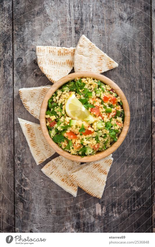 Tabbouleh salad with couscous on a wooden table Table Salad Vegetable Tomato Cucumber Parsley Mint Vegan diet Vegetarian diet Healthy Healthy Eating Nutrition