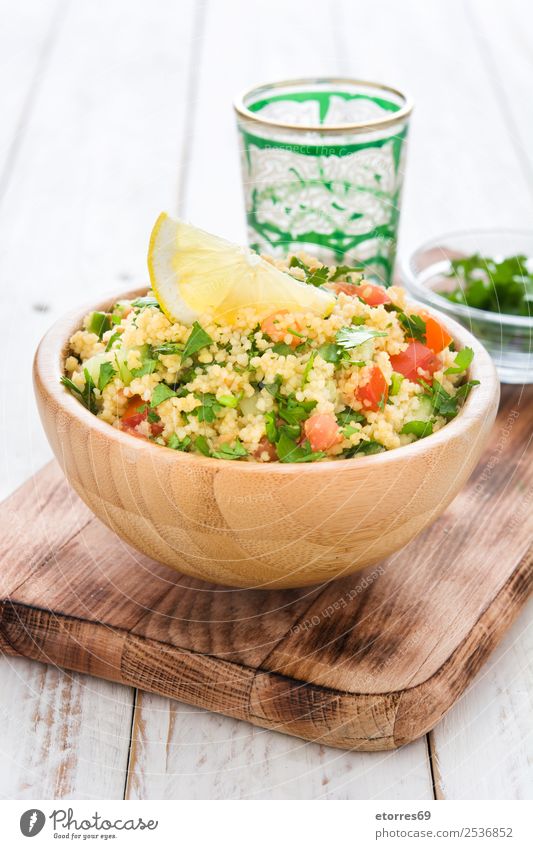 Tabbouleh salad with couscous on a white table Table Salad Vegetable Tomato Cucumber Parsley Mint Vegan diet Vegetarian diet Healthy Healthy Eating Nutrition