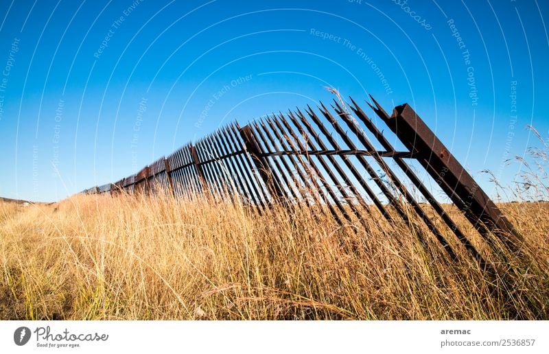Old metal fence in the grass Nature Landscape Sky Cloudless sky Autumn Beautiful weather Grass Meadow South Africa Blue Yellow Emotions Grief damaged cemetry