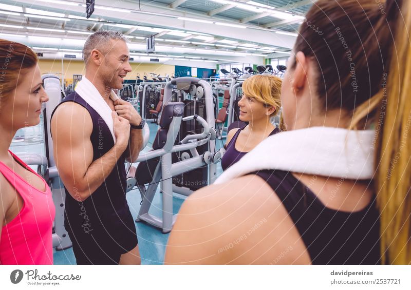 Women talking with personal trainer after training day - a Royalty