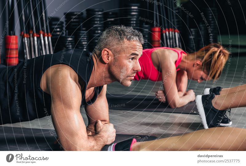 Woman doing push ups in fitness class - a Royalty Free Stock Photo