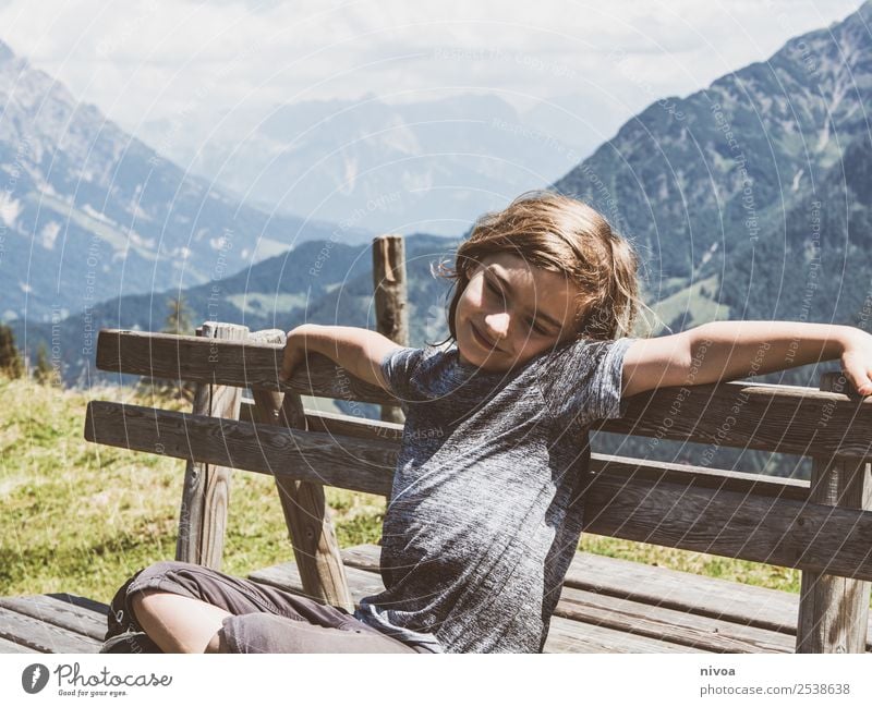 Boy sitting on bench in the background the mountains Vacation & Travel Trip Adventure Far-off places Freedom Summer Summer vacation Mountain Hiking Masculine