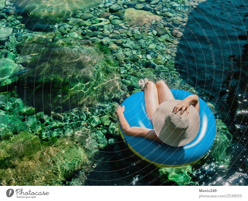 Woman with pamela on a float on a mountain river Human being Feminine Adults Life Body 1 45 - 60 years Nature Water Sun Summer Warmth Rock Mountain River bank