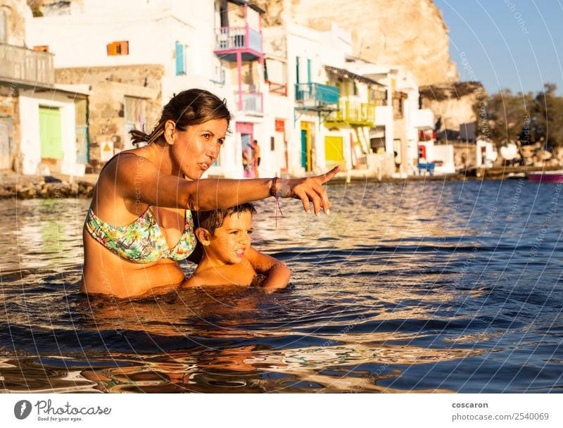 Mother and son playing on the beach inside the water at sunset Lifestyle Joy Happy Beautiful Leisure and hobbies Vacation & Travel Summer Beach Ocean Parenting