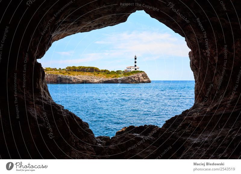 Portocolom Lighthouse on a cliff seen from a cave. Vacation & Travel Tourism Trip Sightseeing Cruise Summer Summer vacation Ocean Island Nature Landscape Coast