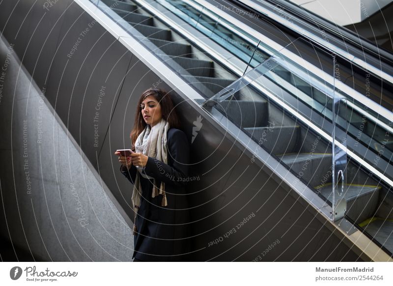 attractive businesswoman using a phone Elegant Beautiful Work and employment Profession Business To talk Telephone Technology Human being Woman Adults Escalator