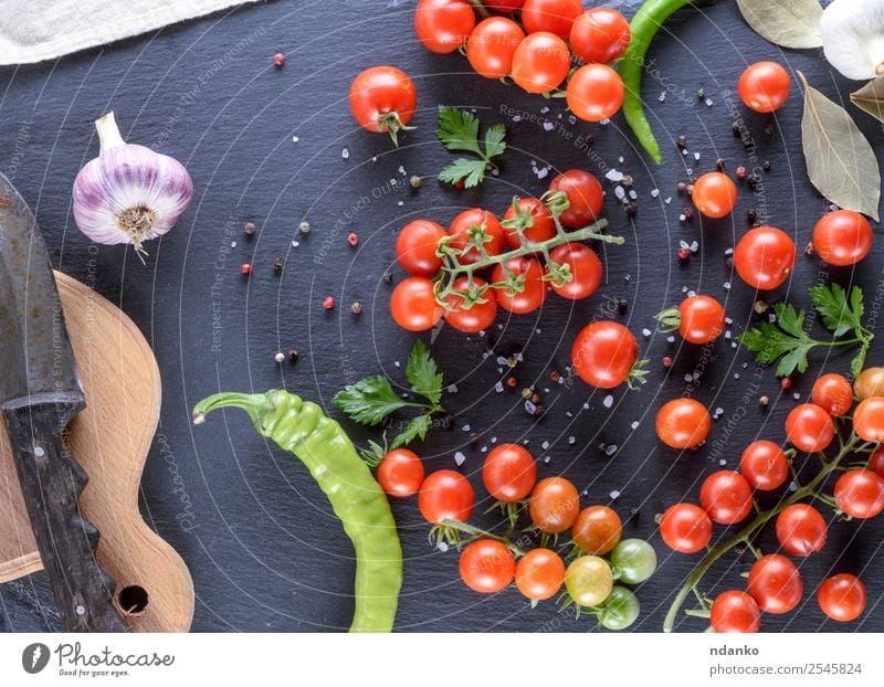 Ripe red cherry tomatoes Vegetable Herbs and spices Knives Wood Fresh Above Red Black Colour Tradition food Tomato Cherry Mature round background Raw dry Tasty