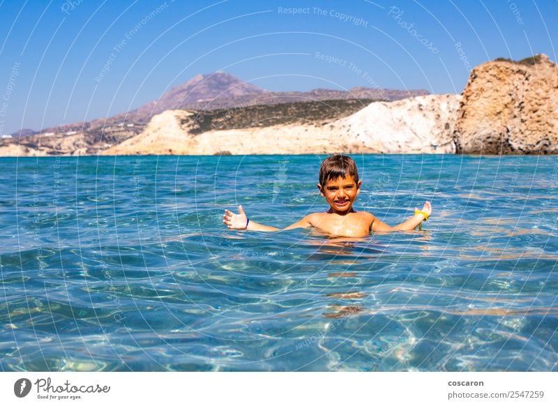 Little boy floating on the sea with transparent water Exotic Joy Happy Beautiful Face Leisure and hobbies Playing Vacation & Travel Summer Beach Ocean Island