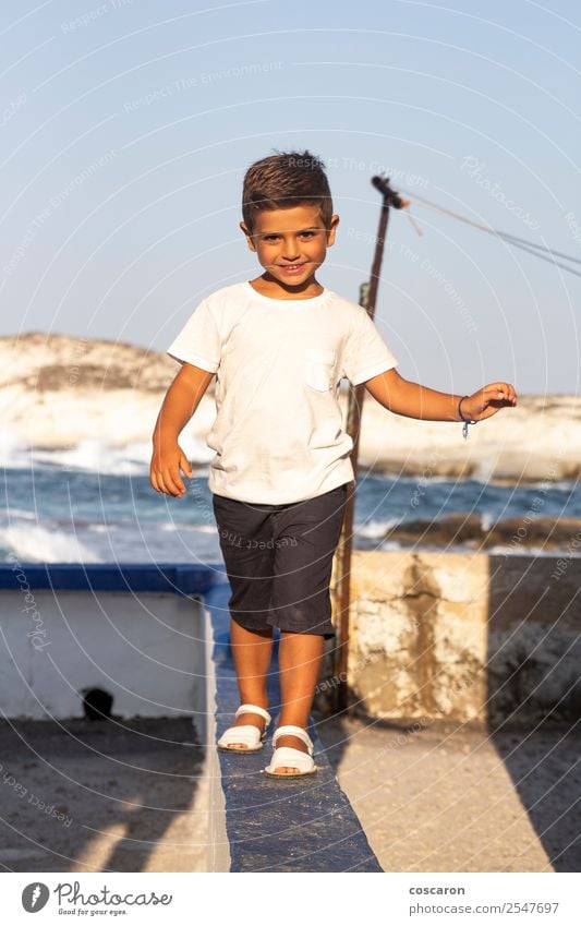 Cute boy doing balance on a wall in summer Joy Beautiful Leisure and hobbies Playing Adventure Summer Child Human being Baby Toddler Boy (child) Infancy 1