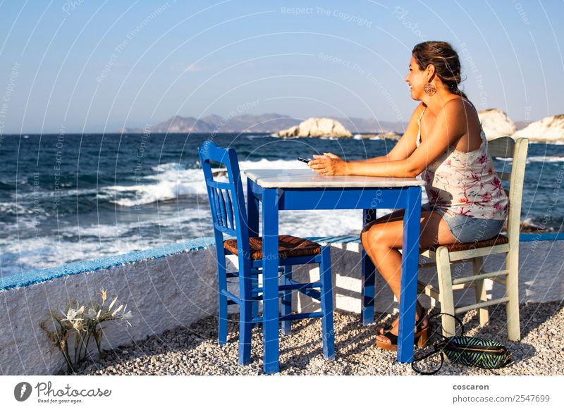 Middle aged woman seated in a table of a restaurant near the sea Coffee Lifestyle Happy Beautiful Vacation & Travel Tourism Summer Beach Ocean Island Table