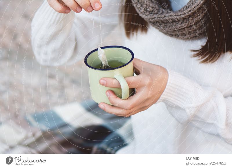 Thermos with a hot drink on mountain waterfall Stock Photo by