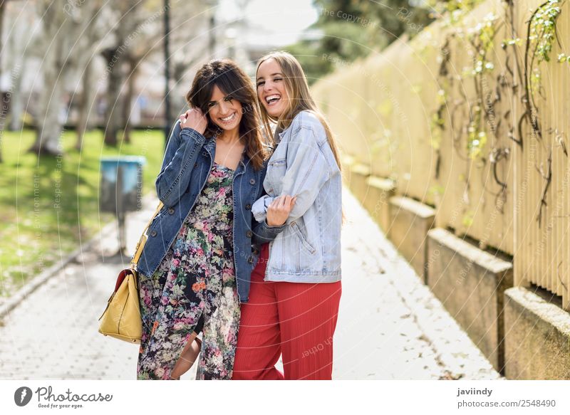 Two happy young women friends hugging in the street Lifestyle Style Joy Happy Beautiful Human being Feminine Young woman Youth (Young adults) Woman Adults