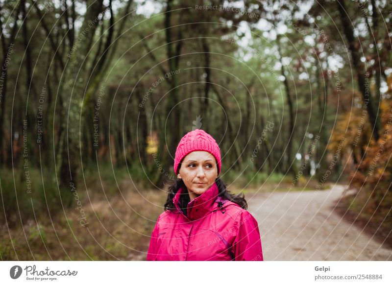 Matured woman with wool pink hat in the forest Lifestyle Beautiful Face Freedom Winter Human being Woman Adults Nature Autumn Tree Leaf Park Forest Fashion Hat
