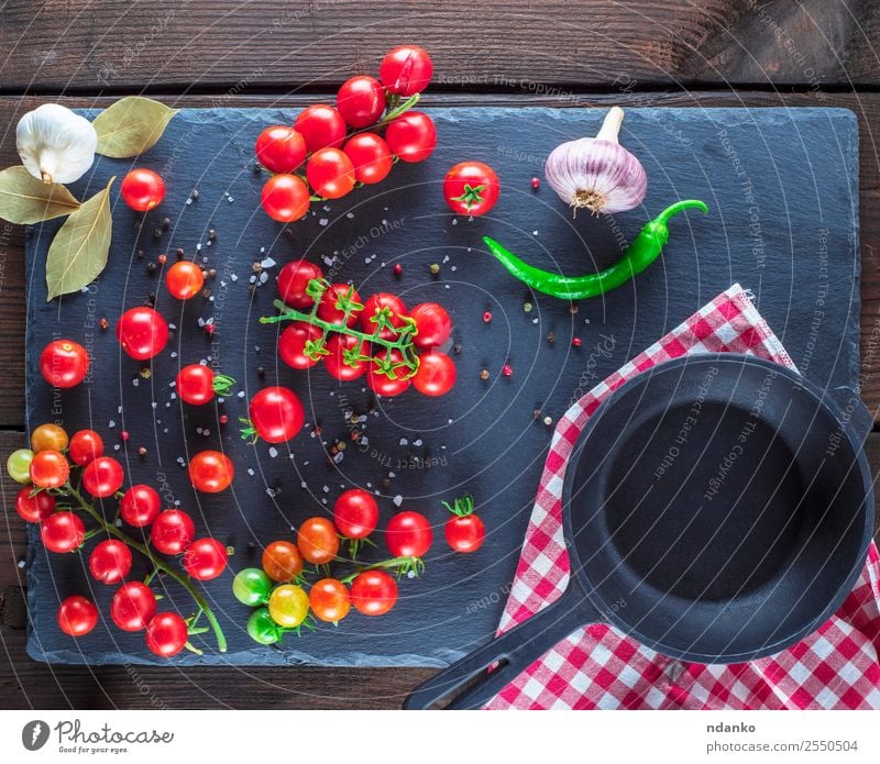 pan and ripe red cherry tomatoes Vegetable Herbs and spices Vegetarian diet Pan Summer Kitchen Wood Eating Fresh Small Natural Above Green Red Black Cherry