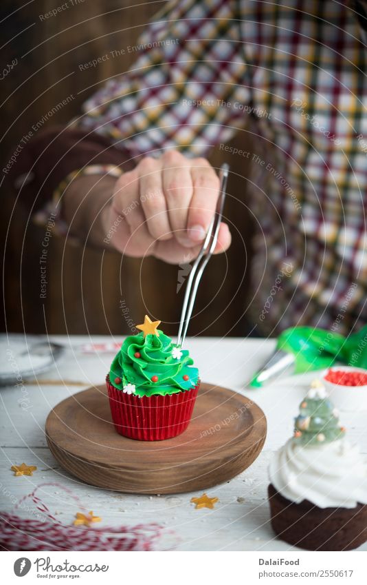 Man making tree cupcake for christmas time Background picture Baking Blur Bright Baked goods Cake Feasts & Celebrations Christmas & Advent Colour Multicoloured