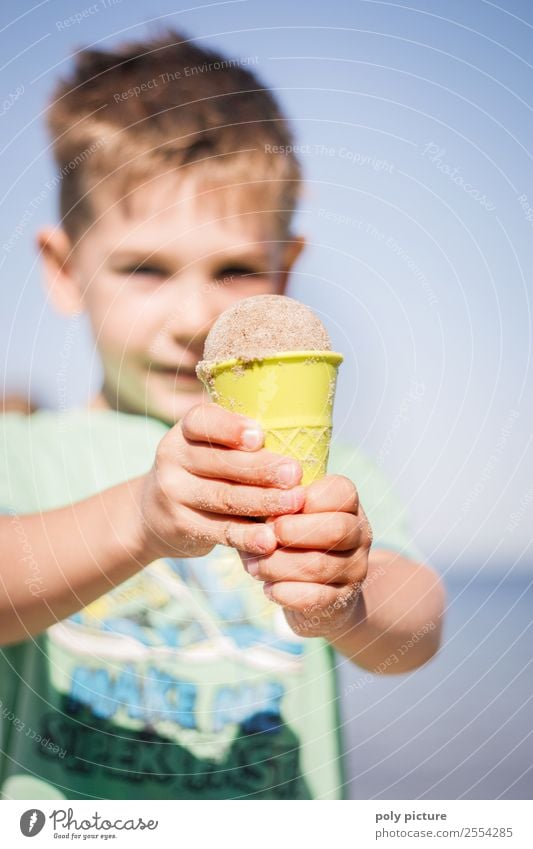 Little boy made an ice cream out of sand. Lifestyle Wellness Vacation & Travel Tourism Trip Adventure Summer Summer vacation Sunbathing Beach Ocean Child