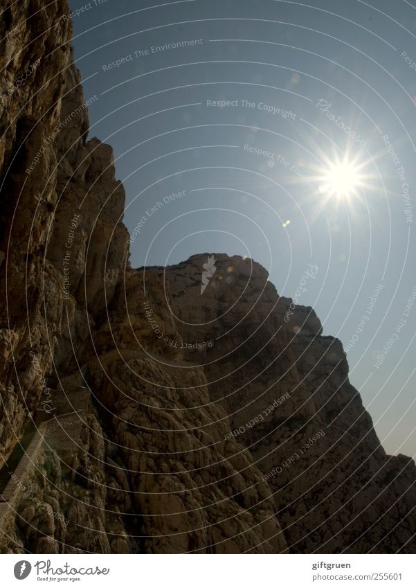 sparkling Environment Nature Landscape Elements Earth Sky Cloudless sky Sun Beautiful weather Rock Mountain Peak Bright Steep face Wall of rock Go up Sunbeam