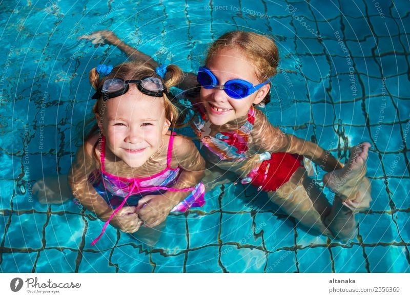 two little girls playing in the pool at the day time Lifestyle Joy Happy Face Relaxation Swimming pool Leisure and hobbies Playing Vacation & Travel Summer Sun