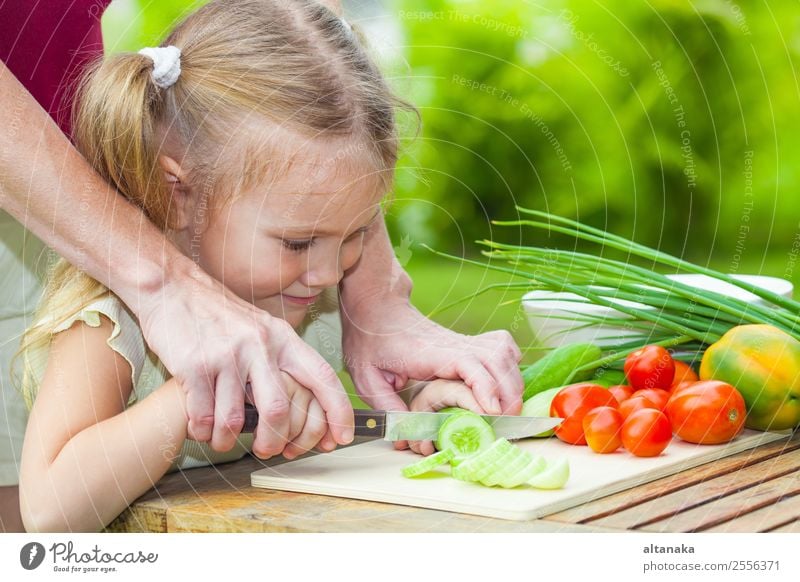 Mother teaches daughter knife cut cucumber Vegetable Eating Dinner Vegetarian diet Diet Lifestyle Summer Table Kitchen Child Human being Adults Nature Steel