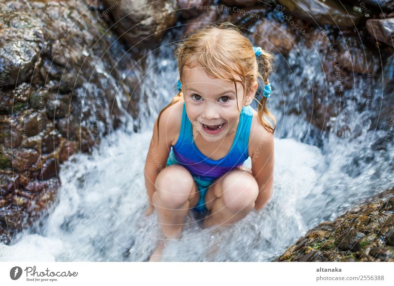 happy girl sitting near the waterfall Lifestyle Joy Happy Face Relaxation Swimming pool Leisure and hobbies Playing Vacation & Travel Summer Child