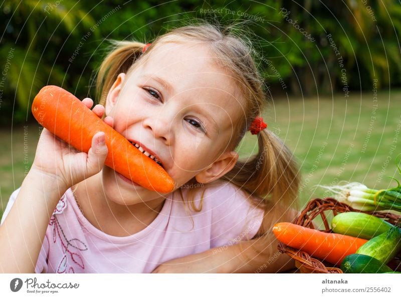 Happy little girl holding a carrots. Vegetable Eating Lifestyle Face Summer Garden Child Gardening Human being Woman Adults Family & Relations Infancy Hand