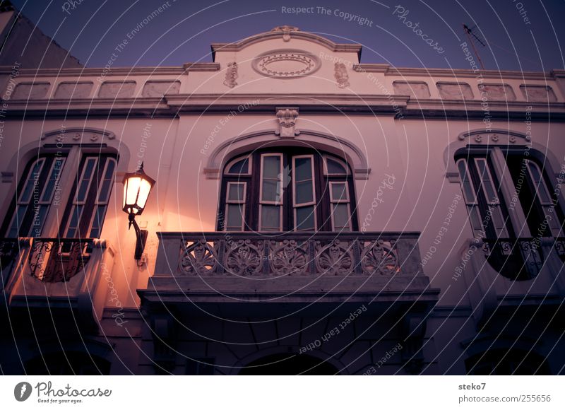 Spanish balcony Cloudless sky House (Residential Structure) Facade Balcony Window Dark Blue Red White Calm Street lighting Architecture Colour photo