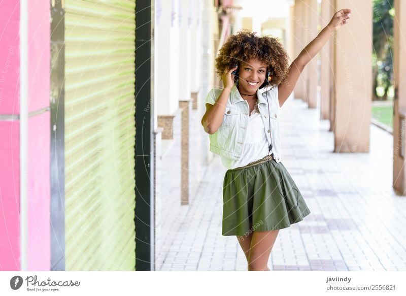 Young attractive black woman in urban street Lifestyle Style Joy Happy Beautiful Hair and hairstyles Face Music Human being Feminine Young woman