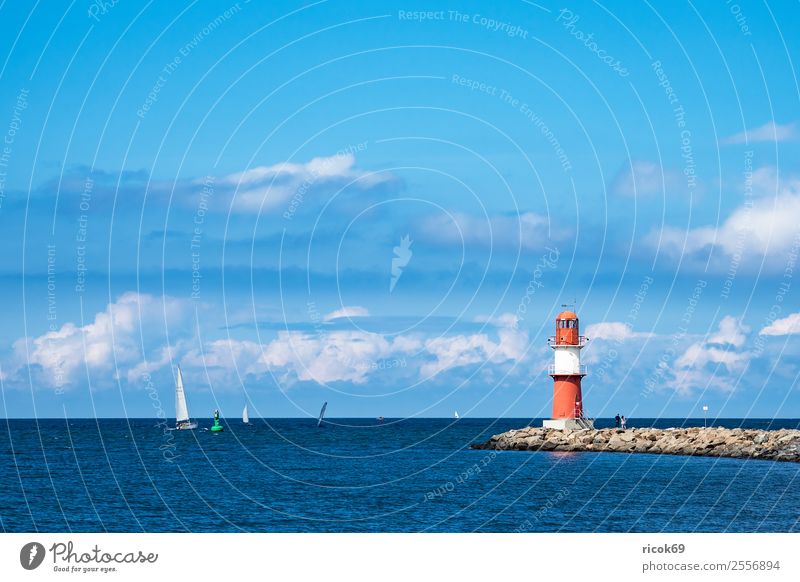 Mole at the Baltic Sea coast in Warnemünde Relaxation Vacation & Travel Tourism Ocean Water Clouds Coast Lighthouse Tourist Attraction Navigation Sailboat