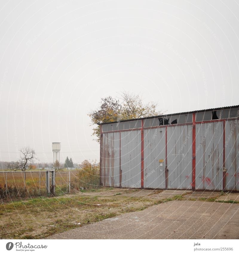 garage Sky Autumn Plant Tree Grass Bushes Places Manmade structures Building Water tower Garage Garage door Gloomy Colour photo Exterior shot Deserted