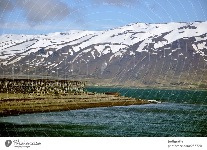 Iceland Environment Nature Landscape Water Beautiful weather Rock Mountain Snowcapped peak Fjord Fishing village Fantastic Cold Natural Fish drying rack Fishery