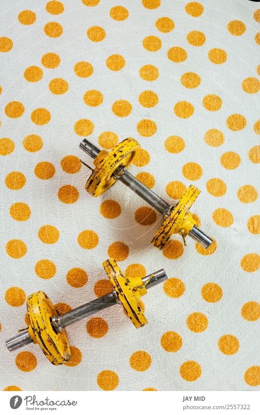 Yellow antique weights on a polka dot towel Lifestyle Sports Fitness Sports Training Metal Steel Rust Diet Old Athletic Free Strong Power Flexible Resolve