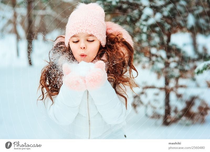 Portrait Of Teenage Girl With Snowflake In Winter Stock Photo