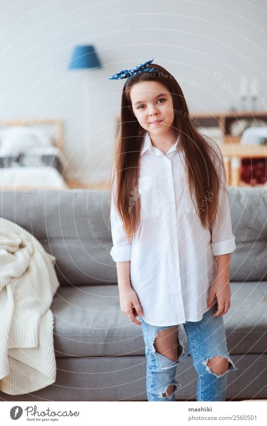vertical portrait of happy 10 years old preteen girl at home Lifestyle Style Joy Relaxation Living room Child Infancy Fashion Shirt Jeans Dress Smiling