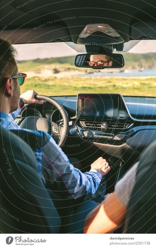 Young man driving a car Lifestyle Vacation & Travel Trip Adventure Technology Human being Woman Adults Man Couple Arm Hand Grass Meadow Coast Transport Vehicle