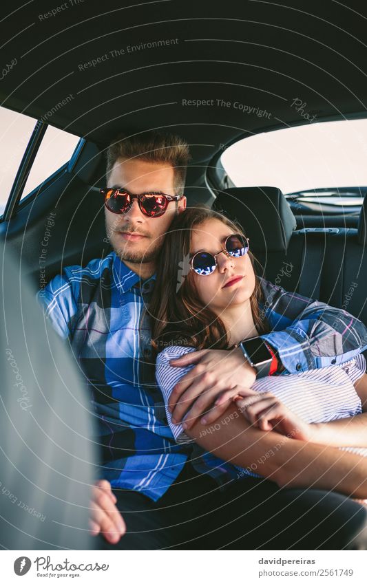 Young couple resting in the backseat of the car Lifestyle Beautiful Relaxation Leisure and hobbies Vacation & Travel Trip Human being Woman Adults Man Couple