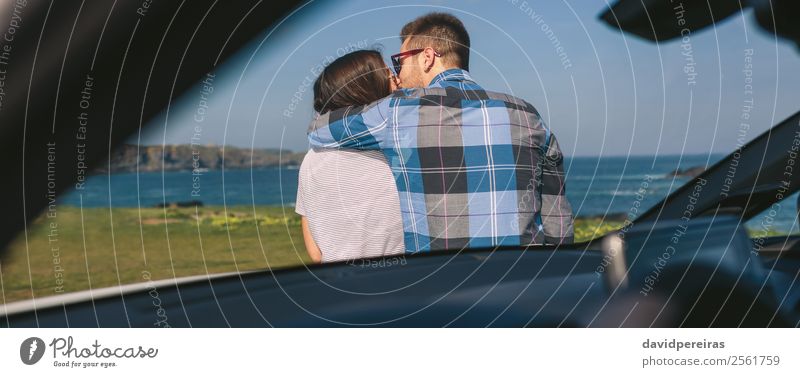 Young couple kissing near the coast Vacation & Travel Trip Adventure Ocean Human being Woman Adults Man Couple Nature Landscape Grass Meadow Coast Car Kissing